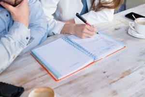 Two people making notes